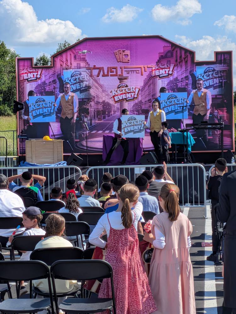 Outdoor show with children watching up front