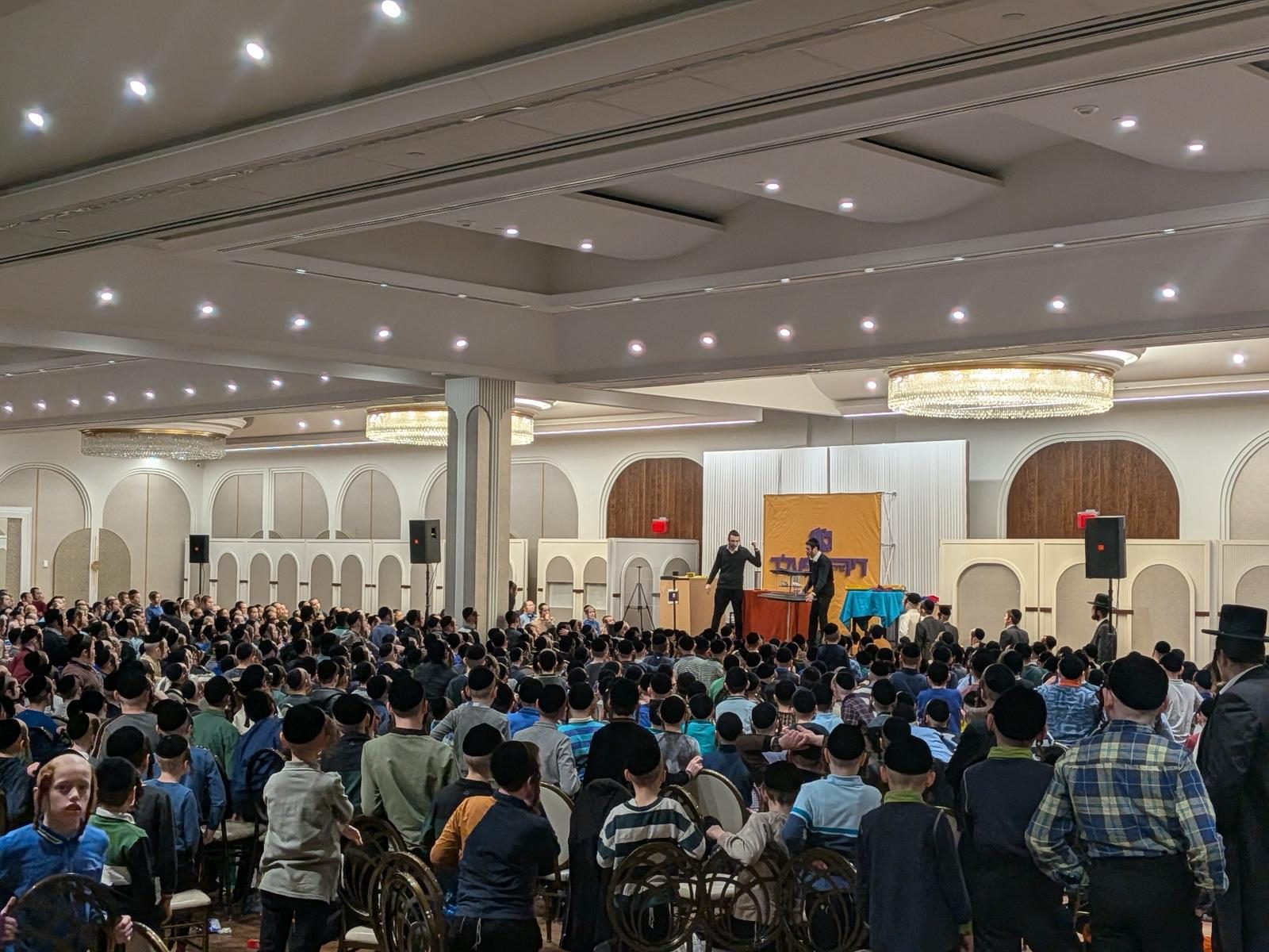 A packed ballroom watching the brothers on stage